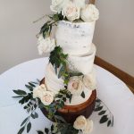 rustic-buttercream-semi-naked-wedding-cake-fresh-ivy-foliage-roses-white-log.jpg